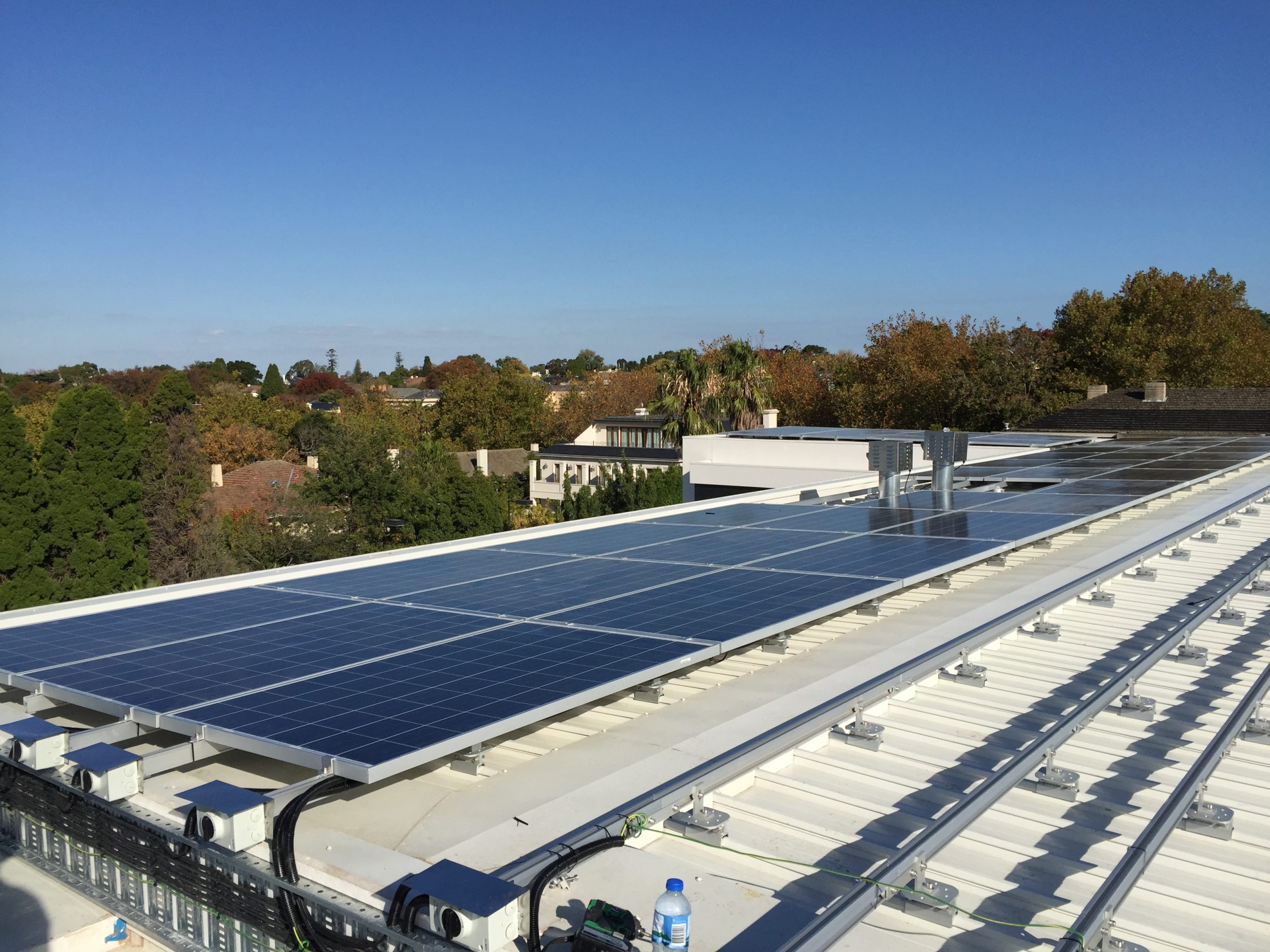 Solar panels installed on tin roof of commercial premises